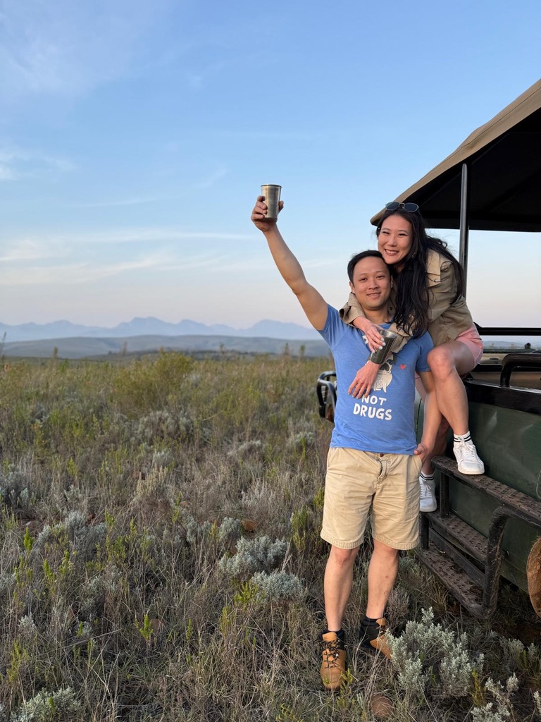 Sunset safari from Cape Town — golden-hour game drive vehicle with Karoo mountains behind at Aquila Private Game Reserve